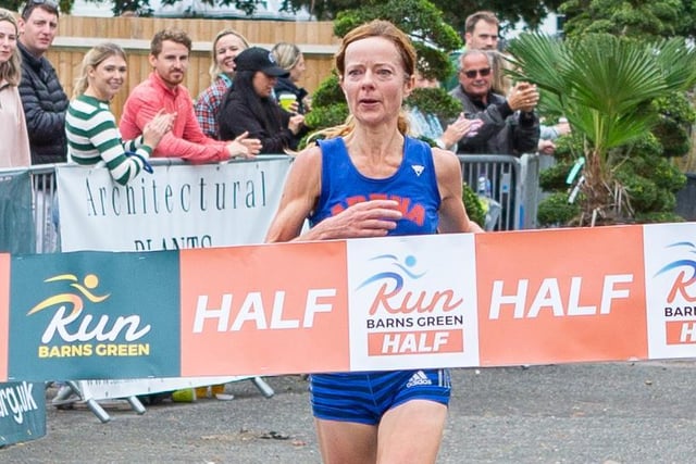 Dani Tarleton crosses the line to finish as first lady in the half marathon