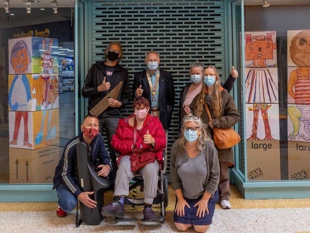 Artists who participate in the weekly music walks along Eastbourne seafront have been presented with a cheque for £500 by local Rotarians. The group are pictured here at the entrance to Compass Community Arts Gallery space and its latest exhibition in the Beacon Centre.