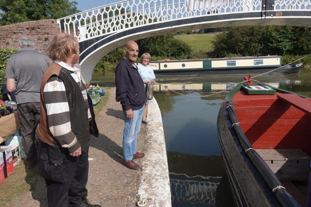 Former working boatman Ron Withey, 82, approving the butty Raymond’s recent makeover, with Chairman Clare Hewitt holding the mooring line.  Picture: Tim Coghlan.