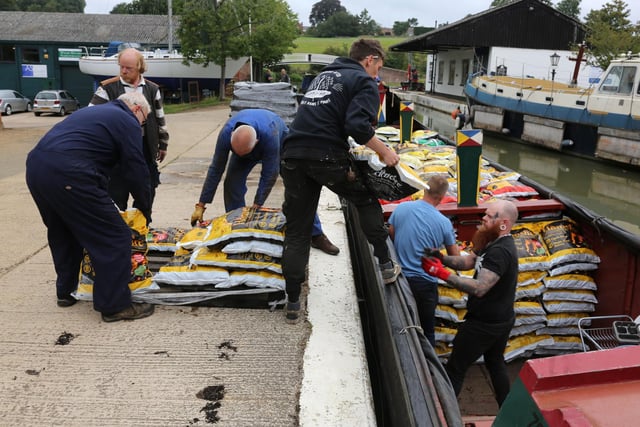 The team of six volunteers from the Narrow Boat Trust in action on the Braunston wharf, where coal has been loaded and unloaded for more than 200 years. Picture: Barry Adams