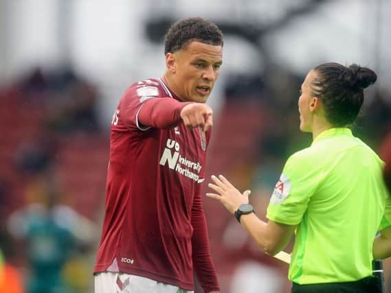 Shaun McWilliams received a yellow card from Rebecca Welch, who became the first female official to referee a Cobblers game. Pictures: Pete Norton.