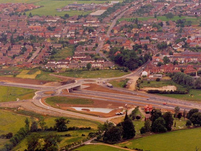 The A14 cuts past Rothwell with the road leading to Loddington seen winding past the cemetery