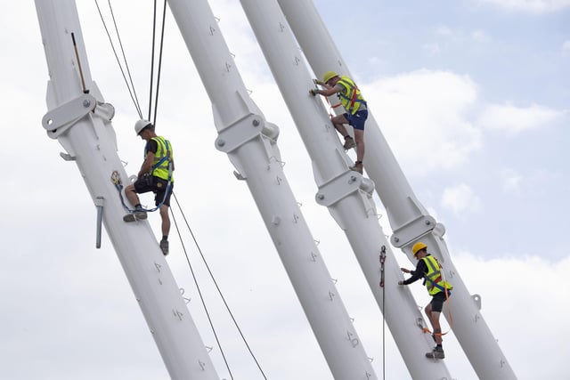 Three workers building the Worthing Observation Wheel in 2019. Picture by Eddie Mitchell