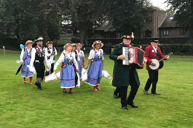 Morris dancers and their band jig thing up