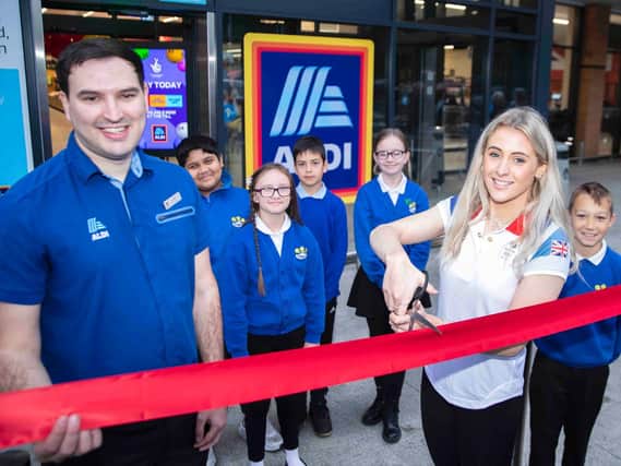 Team GB silver medalist Siobhan-Marie O'Connor cuts the ribbon with Aldi manager Lewis Tew. Photo: Kirsty Edmonds