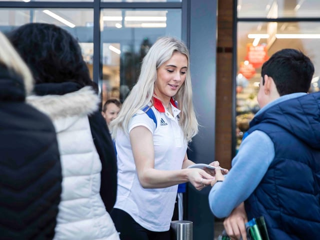 Team GB silver medalist Siobhan-Marie O'Connor signs an autograph for a young fan. Photo: Kirsty Edmonds