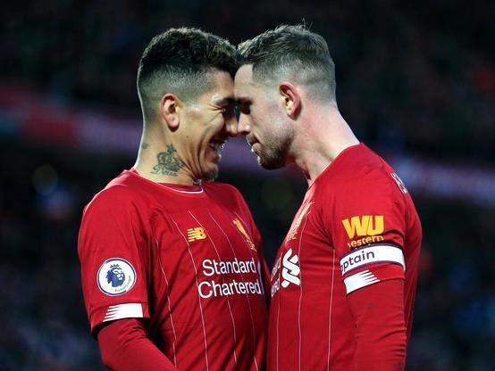 Liverpool captain Jordan Henderson, right, celebrates with Roberto Firmino after scoring during the 4-0 thrashing of Southampton