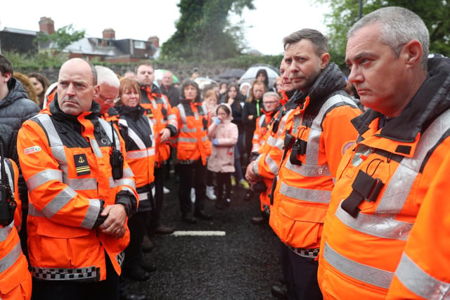 Volunteers from the Community Rescue Service form a guard of honour during the vigil.