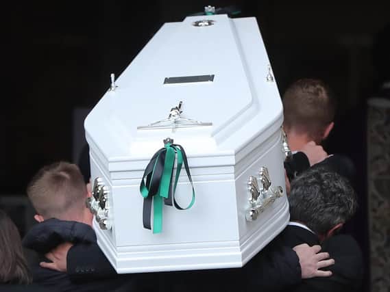 Noah Donohoe's coffin is carried into the church.