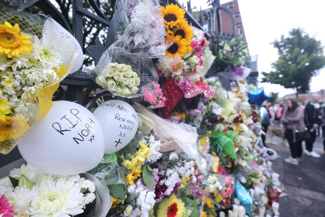 Floral tributes are left outside St. Malachy's College, where Noah was a pupil.