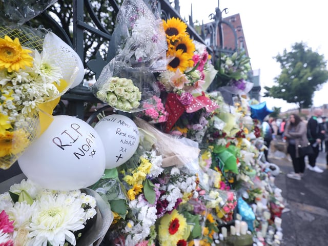 Floral tributes are left outside St. Malachy's College, where Noah was a pupil.