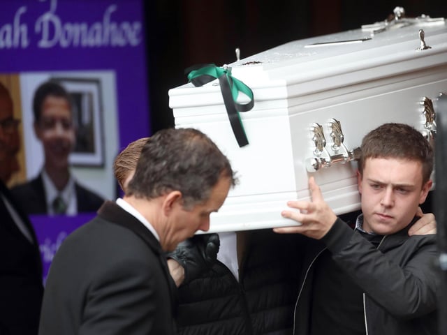 Noah's coffin emerges from the church after Requiem Mass.