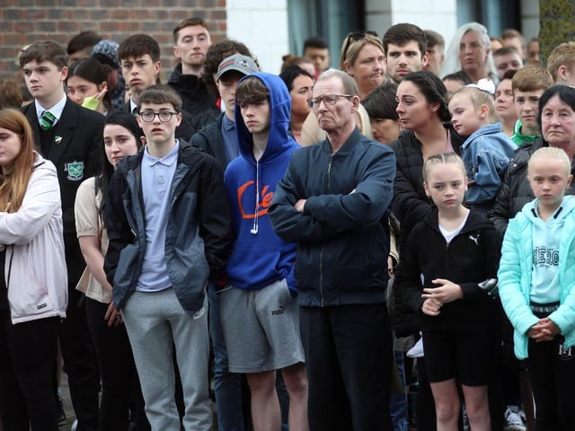 Crowds gather outside.