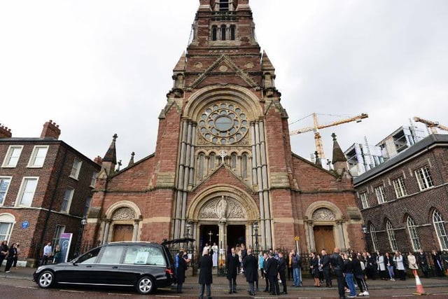 The funeral cortege arrives outside St. Patrick's Church in Belfast.