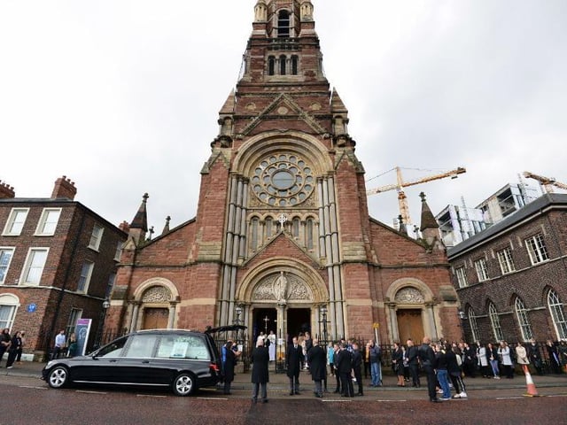 The funeral cortege arrives outside St. Patrick's Church in Belfast.