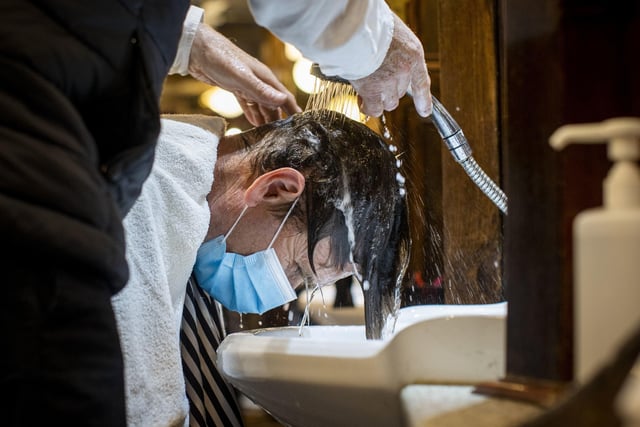 A customer has his hair washed at Cambridge Barbershop on Belfast's Lisburn Road, which opened at 00:01, as hairdressers and beauty salons reopen in Northern Ireland, part of the latest measure to ease coronavirus restrictions