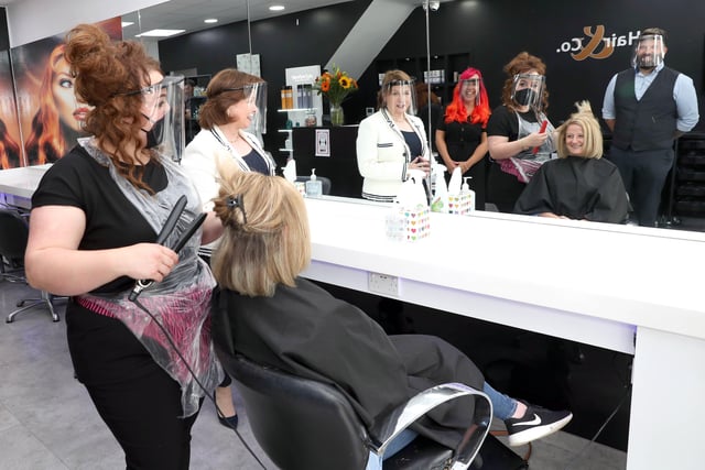 Diane Dodds during a visit to Hair & Co, a family run business based in Newtownards, to see how they were managing with the new safety requirements are salon owners Lyndsey and Aaron Cleland