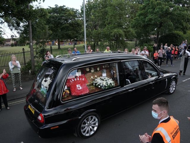 People line the streets as the funeral cortege of Jack Charlton passes through
