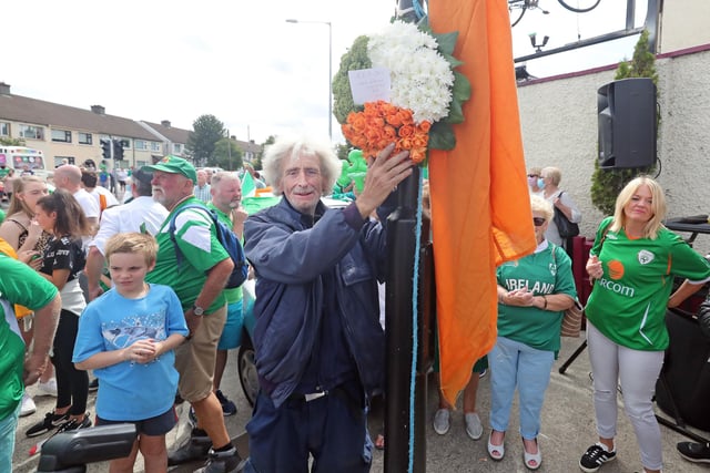 Local man Tom Hickey puts up a wreath as Republic of Ireland fans gather to sing the Ireland world cup anthem "Put em under pressure" at 12:30 Walkinstown Roundabout in Dublin as Jack Charlton's funeral comes to a close in Newcastle England