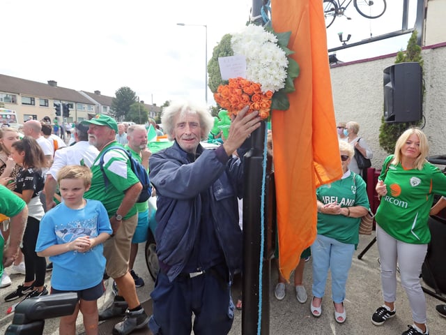 Local man Tom Hickey puts up a wreath as Republic of Ireland fans gather to sing the Ireland world cup anthem "Put em under pressure" at 12:30 Walkinstown Roundabout in Dublin as Jack Charlton's funeral comes to a close in Newcastle England
