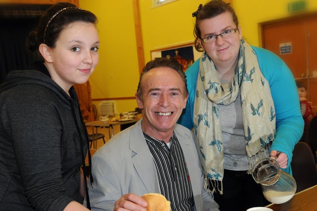 Magherafelt Good Relations officer Sean Henry certainly gets the VIP treatment as he is served fresh pancakes and tea by Tiegan Hunter, committee member and Grainne O'Doherty secretary of the Maghera Youth Connect when he was in attendance at the Maghera Youth Connect first project, a cake stall held at St. Lurach's Parish Hall, Maghera last Saturday morning.mm03-158ar.