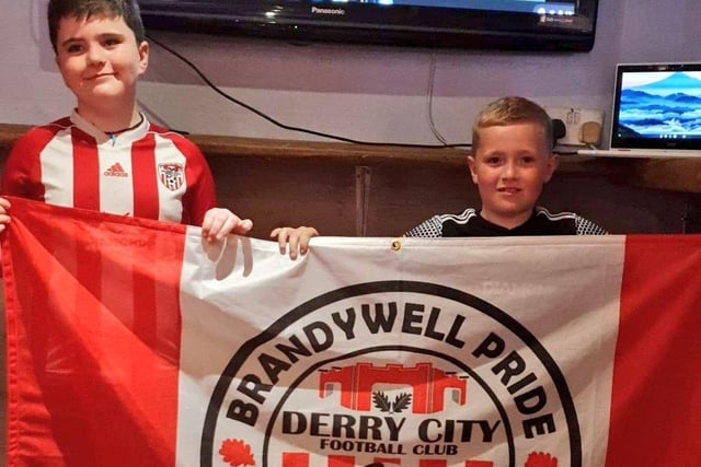 Young City fans, Rossa Williamson and Tiernan McClafferty cheers the team on from their home as they watch on WATCHLOI.