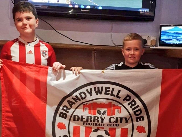 Young City fans, Rossa Williamson and Tiernan McClafferty cheers the team on from their home as they watch on WATCHLOI.