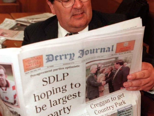 SDLP leader, John Hume , reads a copy of the Derry Journal as he awaits the results of the continuing count for the Foyle seat, in the Northern Ireland Assembly