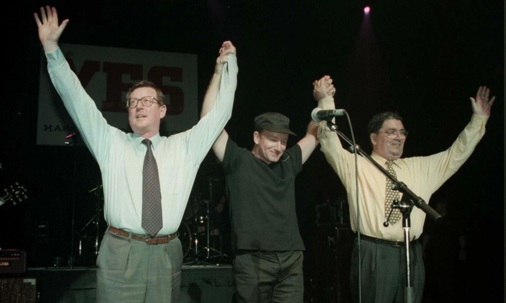 Ulster Unionist leader David Trimble (left), U2 singer Bono, and SDLP leader John Hume on stage for the 'YES' concert at the Waterfront Hall in Belfast