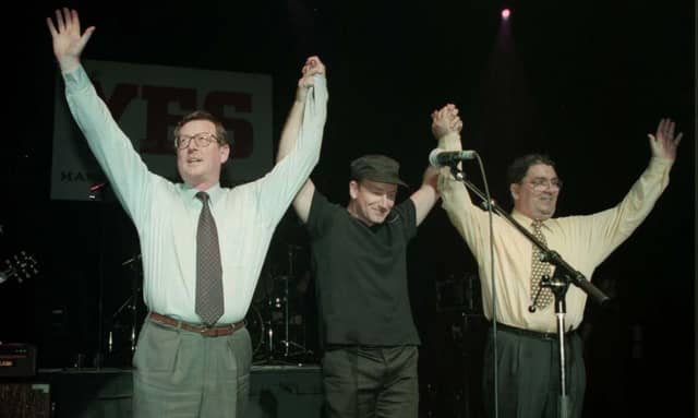 Ulster Unionist leader David Trimble (left), U2 singer Bono, and SDLP leader John Hume on stage for the 'YES' concert at the Waterfront Hall in Belfast