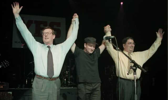 Ulster Unionist leader David Trimble (left), U2 singer Bono, and SDLP leader John Hume on stage for the 'YES' concert at the Waterfront Hall in Belfast