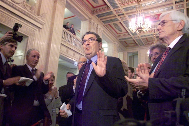 John Hume is applauded by colleagues in the Great Hall of Stormont, Dublin, after he announced his resignation as leader of the SDLP