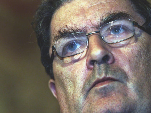John Hume is applauded by colleagues in the Great Hall of Stormont, Belfast, after he announced his resignation as leader of the SDLP