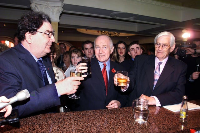 Northern Ireland Secretary of State John Reid (centre) buys John Hume and Seamus Mallon a farewell drink, before Hume's last speech as party leader at the Social Democratic Labour Party's annual conference in Newcastle, Co Down.