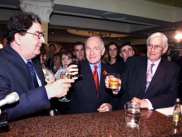 Northern Ireland Secretary of State John Reid (centre) buys John Hume and Seamus Mallon a farewell drink, before Hume's last speech as party leader at the Social Democratic Labour Party's annual conference in Newcastle, Co Down.