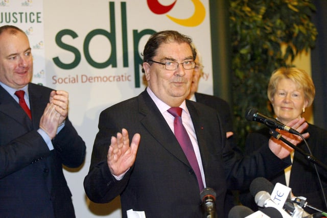 Former SDLP leader John Hume is applauded by his wife Pat and then SDLP leader Mark Durkan after speaking at a press conference in Belfast