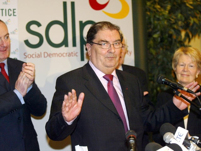 Former SDLP leader John Hume is applauded by his wife Pat and then SDLP leader Mark Durkan after speaking at a press conference in Belfast
