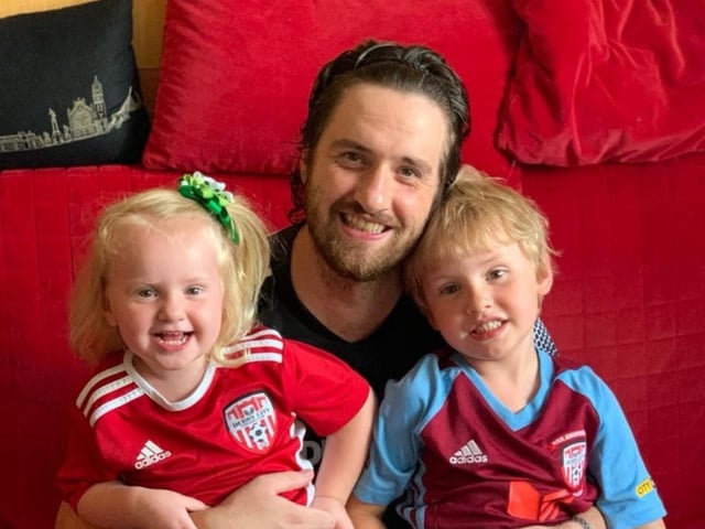 Derry man Brendan Henderson pictured with his daughter Niamh and son Misha in Moscow ready to watch Derry City's clash against Sligo Rovers, on the new WATCHLOI streaming service.