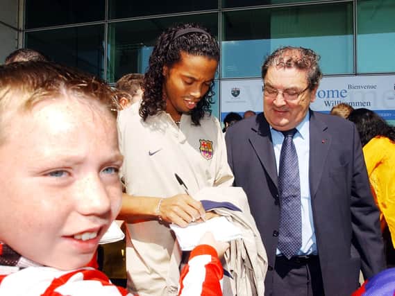 Brazilian Ronaldinho signs autographs for this excited young City fan as John Hume looks on proudly outside City of Derry airport.