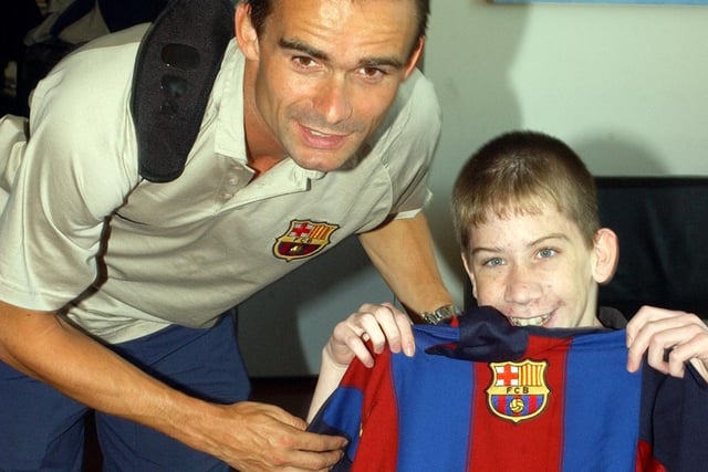 Barcelona star, Marc Overmars poses for a photograph with this lucky Derry City fan .