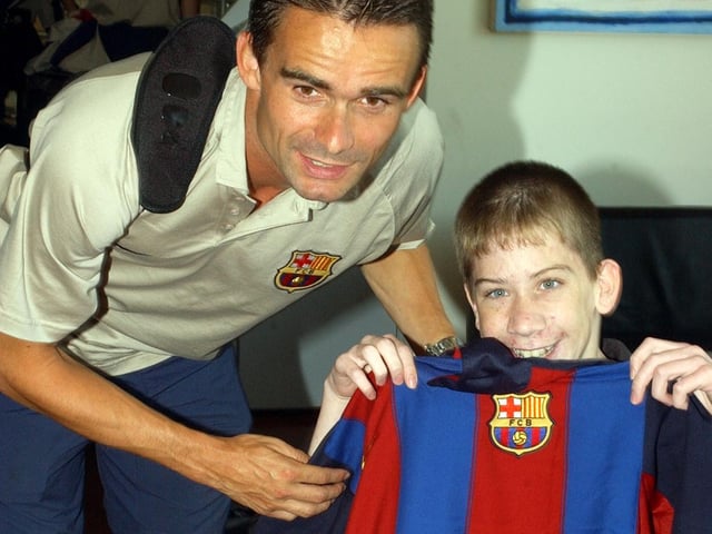 Barcelona star, Marc Overmars poses for a photograph with this lucky Derry City fan .