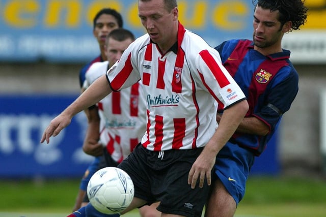 Derry City legend, Liam Coyle is tackled by Barcelona's Mexican defender, Rafael Marquez