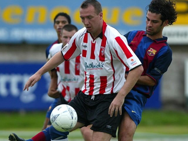 Derry City legend, Liam Coyle is tackled by Barcelona's Mexican defender, Rafael Marquez
