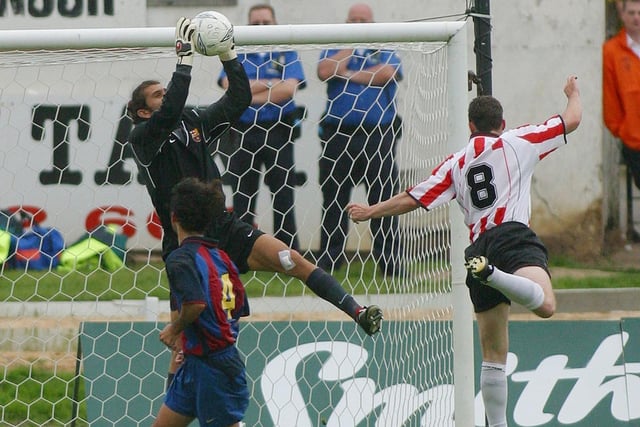 Derry City striker, Gary Beckett tests the reflexes of Barcelona keeper, Victor Valdes during the game which finished 5-0 to the Catalans.