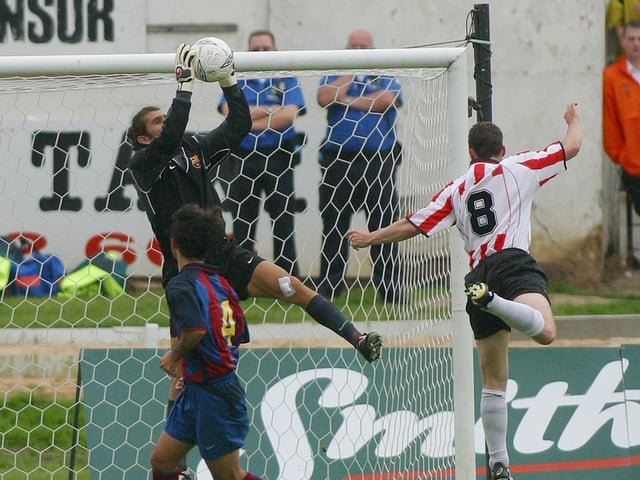 Derry City striker, Gary Beckett tests the reflexes of Barcelona keeper, Victor Valdes during the game which finished 5-0 to the Catalans.