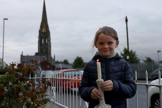 Aoife Bryce with a candle for John Hume