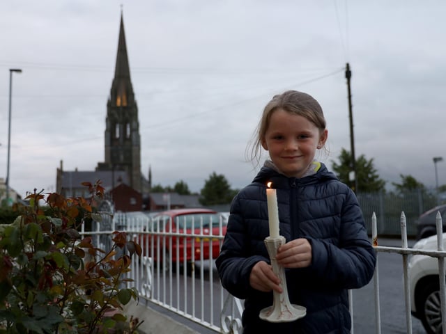 Aoife Bryce with a candle for John Hume