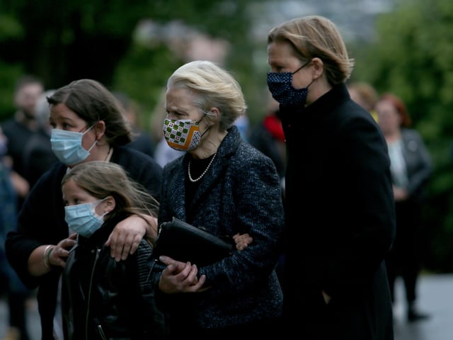 The remains of politician John Hume return to his parish church of St Eugenes . Members of the SDLP and other mourners lined the driveway of the church with candles. His wife Pat, and family were present.