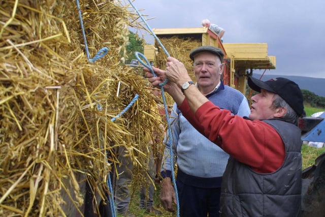 John Mooney and Richard McCurry at the threshing day at Cushendall in October 2002. Picture: Kevin McAuley/Farming Life archives