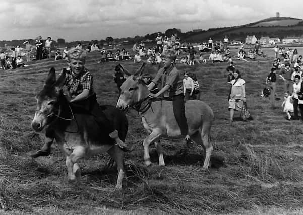 Giddy up, boy! Here's a couple of lads at a donkey derby that was held at Strangford, Co Down in September 1980. Picture: News Letter archives